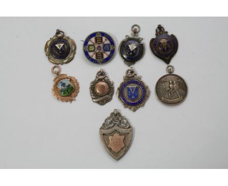 A collection of silver and enamel pendants.