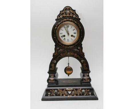 An ebonised and mother of pearl inlaid French mantle clock, the enamel dial with Roman numerals 