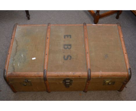 A canvas wooden bound travelling trunk.