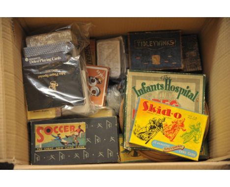 A box containing a quantity of vintage games and playing cards