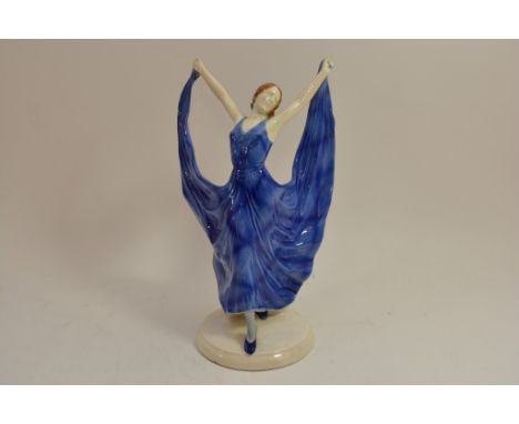 An Art Deco ceramic figure of a lady in a blue dress.