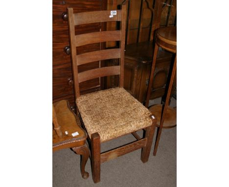 A Stockman rush seated ladder back chair.