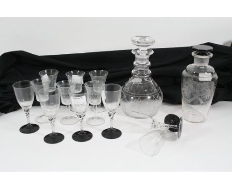 An Art Deco glass decanter and six glasses together with another glass decanter and six Edwardian drinking glasses.