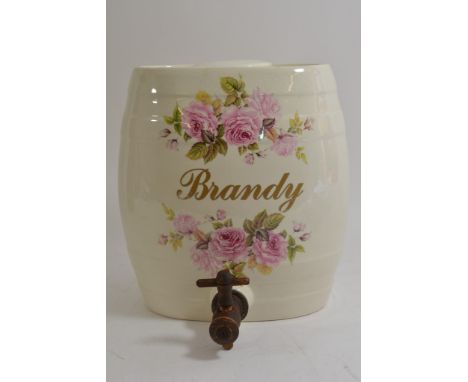 A vintage ceramic brandy barrel with floral decoration with wood tap.
