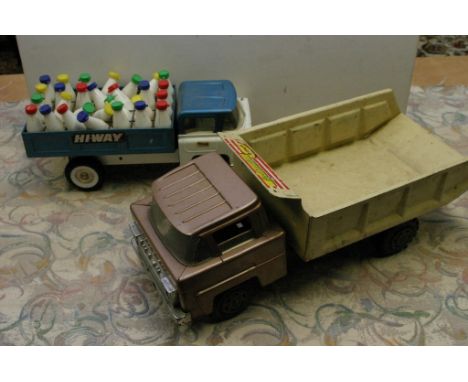 Two Marx tin plate trucks, one with a complete set of milk bottles