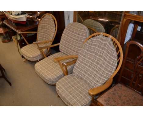 An Ercol lightwood rocking chair with two Windsorback lounge chairs