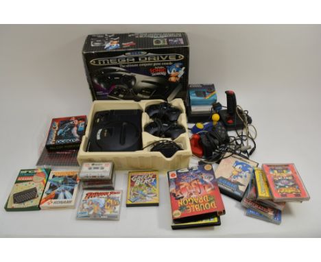 A Sega Mega Drive game console including instructions and spare joysticks plus a large quantity of Spectrum and Sinclair cass