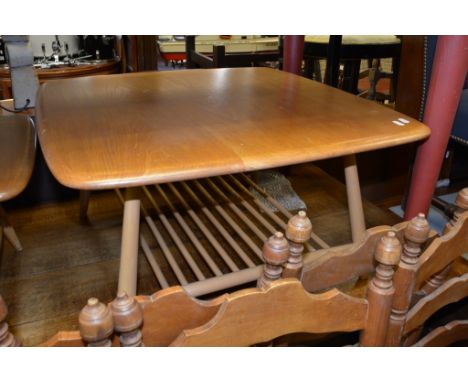 An Ercol light wood square coffee table with undershelf