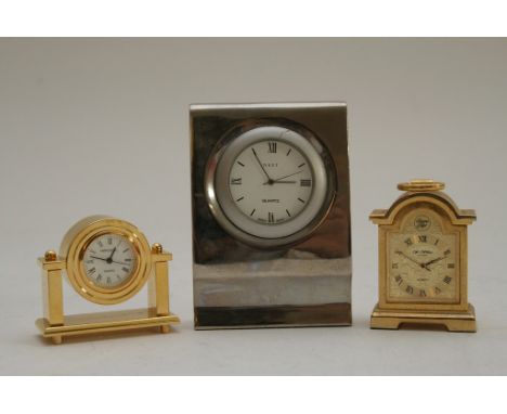 A miniature Brass Carriage Clock, a Next Desk Clock and another miniature Brass Clock in case