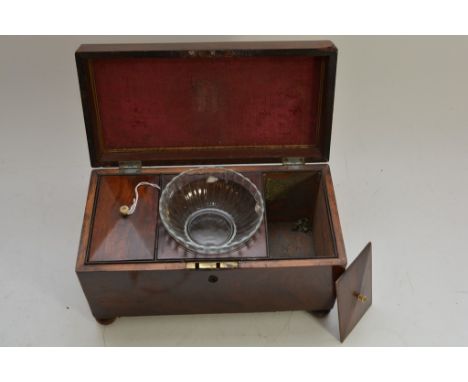 A mahogany tea caddy on bun feet