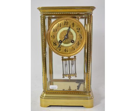 A brass cased four glass mantel clock with mercury pendulum.