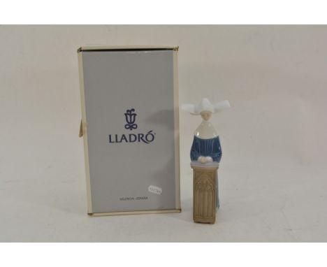 A boxed Lladro figure of a praying nun.