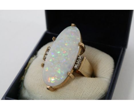 A 9ct gold ring with large Opal flanked by diamonds.