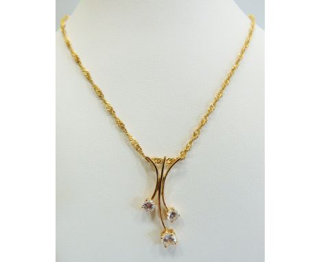 14ct Trident style pendant set with clear CZ gemstones. Hung upon a 14ct , 21 inch chain.  Total weight 3.4g