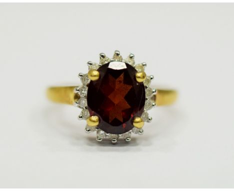 9ct Yellow Gold Ring set with a Large Central Garnet which measures approx 20 x 12mm and is surrounded by 19 melee Diamonds. 