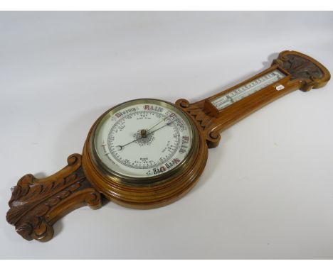 Oak case barometer / thermometer with enamel face. 