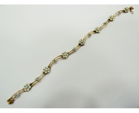 Lovely 9ct Yellow Gold Wave bracelet set with seven, opal cluster flowers and interspersed with seven three cluster Diamond c