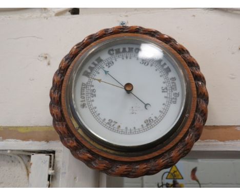 Small enamel faced oak cased barometer, 8" diameter.