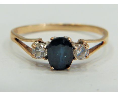 9ct Gold ring set with a Central Sapphire supported by small CZ gemstones to each side.  Finger size 'R'  1.5g