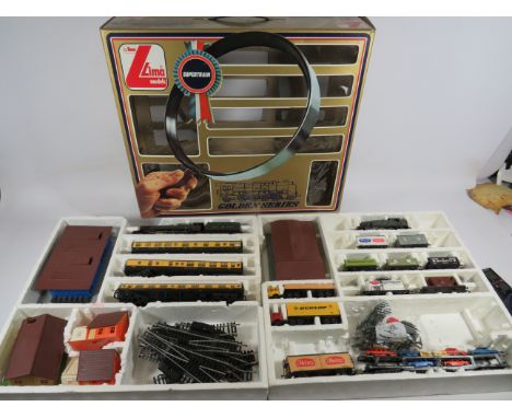 Boxed and part Complete Lima 00 Scale train set.  Engines, Rolling Stock, Trackside buildings.  See photos. 