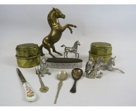 2 brass hub nuts, selection of white metal figurines and a sterling silver tea caddy spoon.