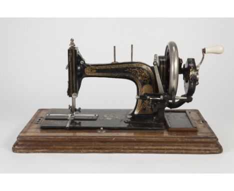 LATE 19th CENTURY TABLE TOP SEWING MACHINE with folding handle, gilt Greek key and foliate scroll decoration, mother of pearl