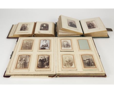TWO VICTORIAN SMALL PHOTOGRAPH ALBUMS with embossed leather bindings and metal hasps, approx 6" x 5" (15.3cm x 12.7cm), conta