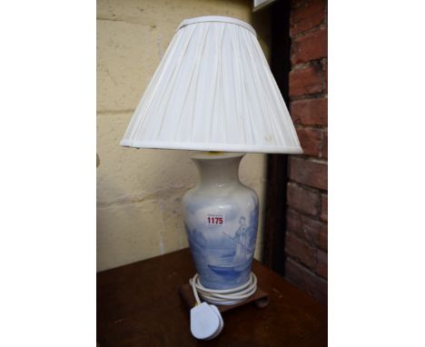 A blue and white pottery lamp base, painted with women in a punt; together with a Moore Bros figural centrepiece, (a.f.); ano