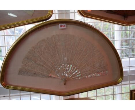An antique mother of pearl and lace fan, the guard 24cm long, in a gilt fan shaped box, 62.5cm wide; together with another si