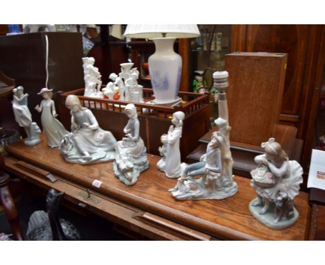 Six Lladro figures; together with another Nao figure. 