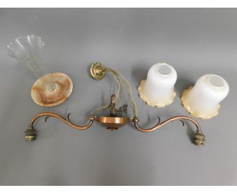 A copper ceiling lamp with two glass shades twinned with a glass epergne