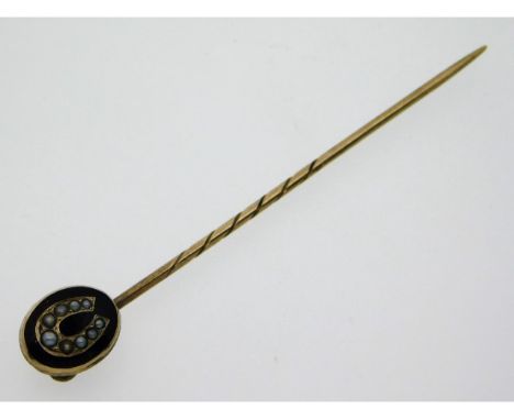 A Victorian yellow metal tie pin, tests as gold, set with pearl on black enamel, 2.5in long, 2.7g