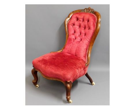A 19thC. rosewood button back nursing chair, 35.5in high to back