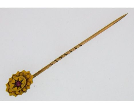 A 9ct gold tie pin set with ruby, 51mm long, 1.1g