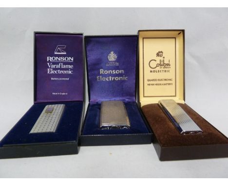 Three cigarette lighters - comprising a Colibri Molectric, silvered 'engine-turned' fluted finish, box, outer box and papers;