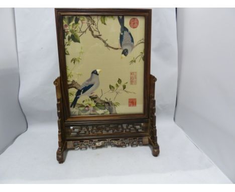 A Chinese embroidered silk face screen, the double sided image of birds in fruiting branches, three seal marks worked in red,