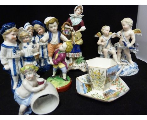 Five German porcelain figures, comprising a pair of 'Twin' figures, each of a boy and a girl; a SPM putti group; a female str