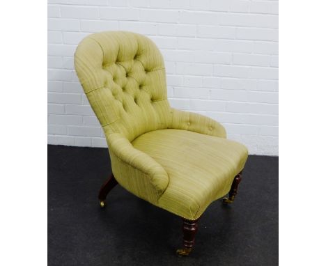 Upholstered button back armchair, on turned mahogany legs with brass caps and castors, 83 x 62cm 