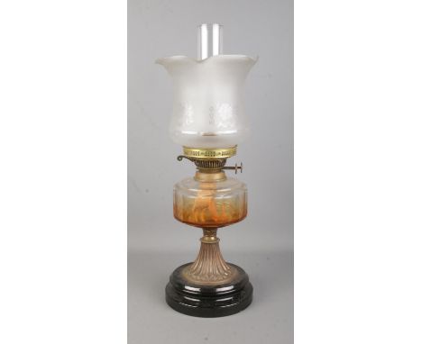 A 'British Made' brass and glass oil lamp, raised on stepped circular base, with frosted glass shade. Height: 54cm.