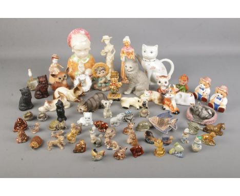 A collection of Wade Whimsie figures with an assortment of other ceramic animal figures and other ceramics