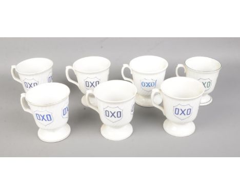 A collection of seven vintage ceramic OXO advertising mugs.