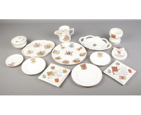 A collection of large Goss crested ware including plates, wall plaques, jug, marmalade pot etc