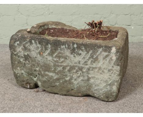 A stone garden planter of rectangular form. Dimensions: 24cm x 46cm x 37cm.