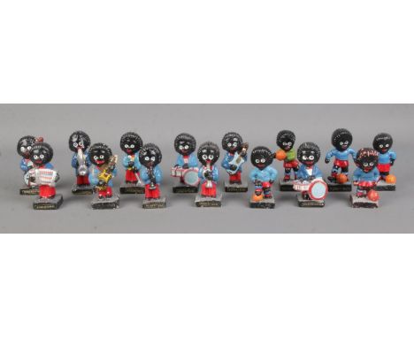 A collection of Robertson and similar Golly figures, containing musician and sporting examples. Balls loose on some of the sp
