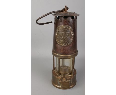 An Eccles Type 6 miners safety lamp by the Protector Lamp and Lighting Co. Ltd. Stamped No. 29.