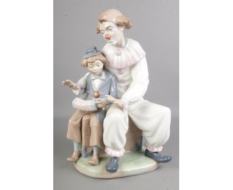 A large Nao by Lladro 'Lesson of Music' No 701 figure, designed by Vicente Martinez of a clown teaching a young boy the accor