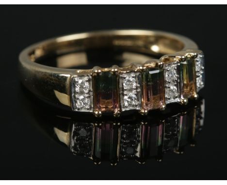A 9ct Gold ring, set with 'watermelon' bi-coloured tourmaline stones between rows of two diamonds. Size P. Total weight: 2.4g