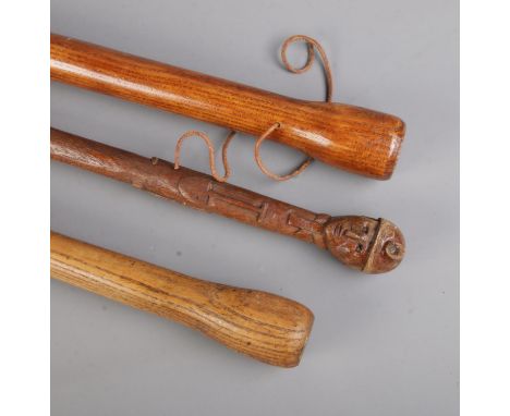 Three miners hand carved walking canes to include example with pommel formed as the head of a miners surrounded by a collecti