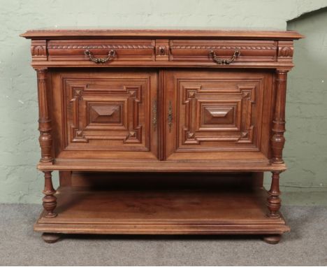 A heavily carved marble topped French buffet sideboard featuring two drawers, cupboard and lower shelf. Approx. dimensions 12