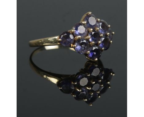 A 14ct Gold Iolite cluster ring, with nine stones set in a diamond formation. Size N½. Total weight: 3.0g Stamped 14k to insi